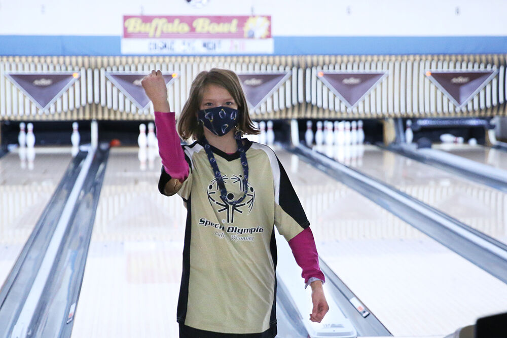 Payten Parsons waves her fist in celebration of knocking down all but two pins